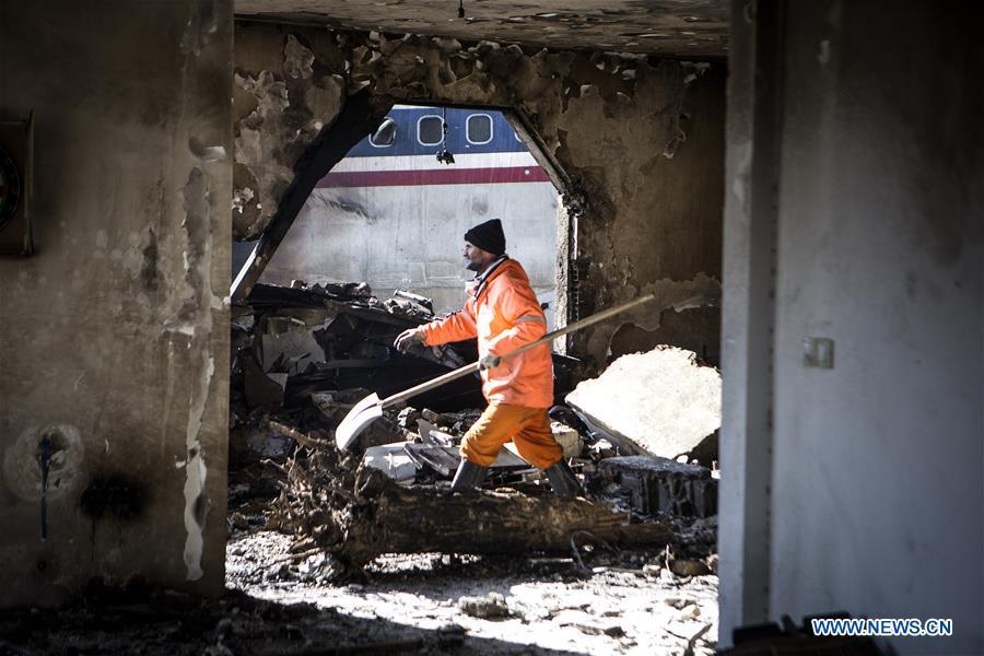 A rescuer works at the crash site of a Boeing 707 plane in Karaj, Iran, Jan. 14, 2019. At least 15 people were killed on Monday in the crash. (Xinhua/Ahmad Halabisaz)