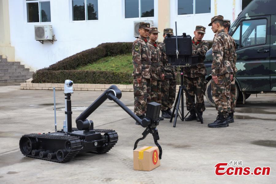 Armed police control a bomb disposal device during a training exercise in Guizhou Province, Jan. 14, 2019. Wearing anti-explosion coveralls weighing 30 kilograms each, members of the armed police unit specializing in explosive ordnance disposal conducted a drill on Monday, aided by a remotely-controlled bomb disposal device. (Photo: China News Service/Qu Honglun)