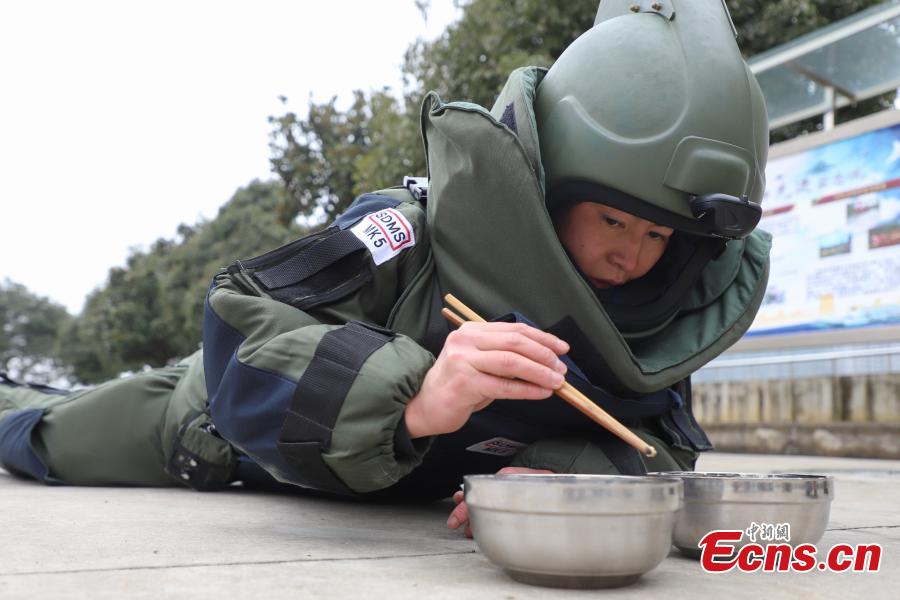 Deng Yutang, a member of the armed police bomb squad, takes part in a training exercise in Guizhou Province, Jan. 14, 2019. Wearing anti-explosion coveralls weighing 30 kilograms each, members of the armed police unit specializing in explosive ordnance disposal conducted a drill on Monday, aided by a remotely-controlled bomb disposal device. (Photo: China News Service/Qu Honglun)