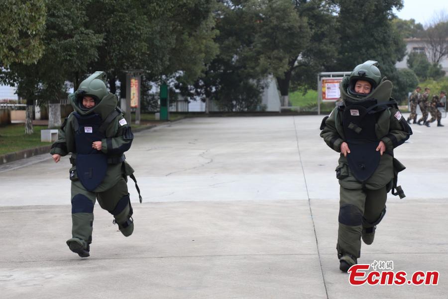 <?php echo strip_tags(addslashes(Li Degui (R) and Deng Yutang, both wearing anti-explosion coveralls, compete during a training in Guizhou Province, Jan. 14, 2019. Wearing anti-explosion coveralls weighing 30 kilograms each, members of the armed police unit specializing in explosive ordnance disposal conducted a drill on Monday, aided by a remotely-controlled bomb disposal device. (Photo: China News Service/Qu Honglun))) ?>