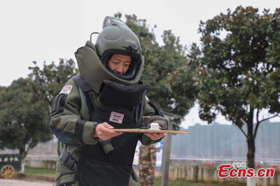 <?php echo strip_tags(addslashes(Li Degui, a member of the armed police bomb squad, balances himself during a training exercise in Guizhou Province, Jan. 14, 2019. Wearing anti-explosion coveralls weighing 30 kilograms each, members of the armed police unit specializing in explosive ordnance disposal conducted a drill on Monday, aided by a remotely-controlled bomb disposal device. (Photo: China News Service/Qu Honglun))) ?>