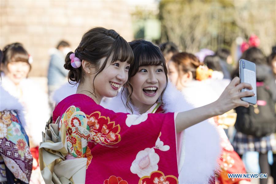 Japanese girls in kimonos take selfies to celebrate Coming of Age together at Tokyo Disneyland in Chiba, Japan, Jan. 14, 2019. People who turned 20-year-old took part in the annual Coming of Age Day ceremony in Japan on Monday. (Xinhua/Du Xiaoyi)