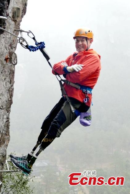 Double amputee Xia Boyu attempts a via ferrata climbing route at Shenxianju, a geological site known for its cliffs and waterfalls, in Taizhou City, East China\'s Zhejiang Province, Jan. 14, 2019. A via ferrata is a protected climbing route. Xia became a double amputee after suffering severe frostbite in both feet while attempting to climb Mount Qomolangma in 1975. The 70 year old scaled the world\'s highest peak as the first double amputee climber from the Nepali side on May 14, 2018. (Photo: China News Service/Ying Jianfei)