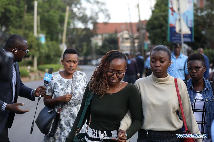 People are seen near the site of an attack at an upmarket hotel and office complex in Nairobi, Kenya, on Jan. 15, 2019. At least six people have been confirmed dead and several others injured following an attack at an upmarket hotel and office complex in Nairobi on Tuesday, police said. (Xinhua/Wang Teng)