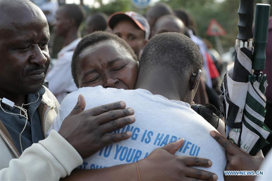 People embrace each other after an evacuation near the site of an attack at an upmarket hotel and office complex in Nairobi, Kenya, on Jan. 15, 2019. At least six people have been confirmed dead and several others injured following an attack at an upmarket hotel and office complex in Nairobi on Tuesday, police said. (Xinhua/Lyu Shuai)