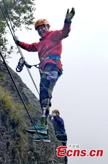 Double amputee Xia Boyu attempts a via ferrata climbing route at Shenxianju, a geological site known for its cliffs and waterfalls, in Taizhou City, East China\'s Zhejiang Province, Jan. 14, 2019. A via ferrata is a protected climbing route. Xia became a double amputee after suffering severe frostbite in both feet while attempting to climb Mount Qomolangma in 1975. The 70 year old scaled the world\'s highest peak as the first double amputee climber from the Nepali side on May 14, 2018. (Photo: China News Service/Ying Jianfei)