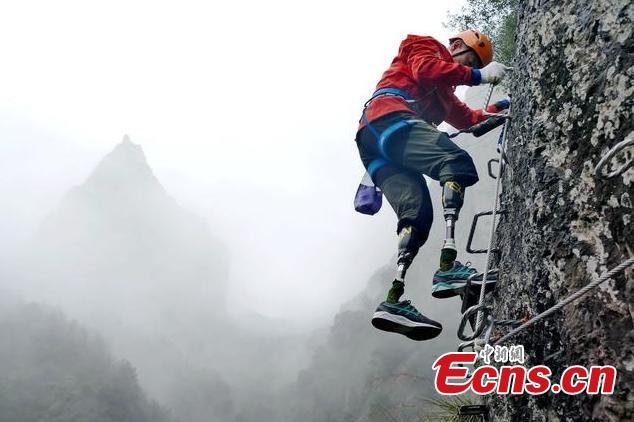 Double amputee Xia Boyu attempts a via ferrata climbing route at Shenxianju, a geological site known for its cliffs and waterfalls, in Taizhou City, East China\'s Zhejiang Province, Jan. 14, 2019. A via ferrata is a protected climbing route. Xia became a double amputee after suffering severe frostbite in both feet while attempting to climb Mount Qomolangma in 1975. The 70 year old scaled the world\'s highest peak as the first double amputee climber from the Nepali side on May 14, 2018. (Photo: China News Service/Ying Jianfei)