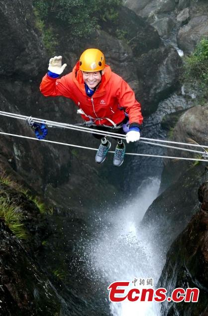 Double amputee Xia Boyu attempts a via ferrata climbing route at Shenxianju, a geological site known for its cliffs and waterfalls, in Taizhou City, East China\'s Zhejiang Province, Jan. 14, 2019. A via ferrata is a protected climbing route. Xia became a double amputee after suffering severe frostbite in both feet while attempting to climb Mount Qomolangma in 1975. The 70 year old scaled the world\'s highest peak as the first double amputee climber from the Nepali side on May 14, 2018. (Photo: China News Service/Ying Jianfei)