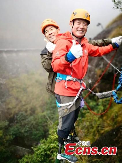 Double amputee Xia Boyu attempts a via ferrata climbing route at Shenxianju, a geological site known for its cliffs and waterfalls, in Taizhou City, East China\'s Zhejiang Province, Jan. 14, 2019. A via ferrata is a protected climbing route. Xia became a double amputee after suffering severe frostbite in both feet while attempting to climb Mount Qomolangma in 1975. The 70 year old scaled the world\'s highest peak as the first double amputee climber from the Nepali side on May 14, 2018. (Photo: China News Service/Ying Jianfei)