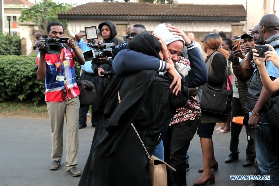 People embrace each other after an evacuation near the site of an attack at an upmarket hotel and office complex in Nairobi, Kenya, on Jan. 15, 2019. At least six people have been confirmed dead and several others injured following an attack at an upmarket hotel and office complex in Nairobi on Tuesday, police said. (Xinhua/Lyu Shuai)