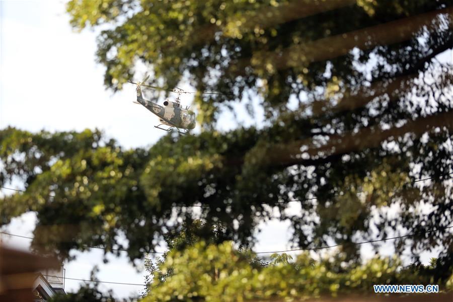 A helicopter hovers near the site of an attack at an upmarket hotel and office complex in Nairobi, Kenya, on Jan. 15, 2019. At least six people have been confirmed dead and several others injured following an attack at an upmarket hotel and office complex in Nairobi on Tuesday, police said. (Xinhua/Wang Teng)