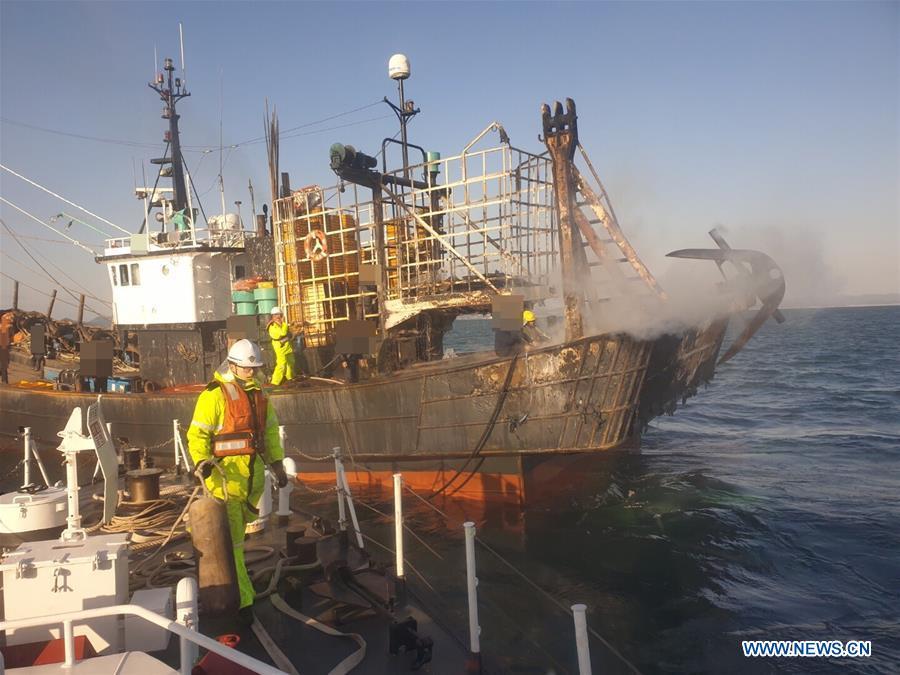 Marine policemen work on the fishing boat in the southwest waters of South Korea, Jan. 17, 2019. A fishing boat caught fire in the southwest waters of South Korea on Thursday morning, leaving one person dead, one missing and one wounded. (Xinhua)