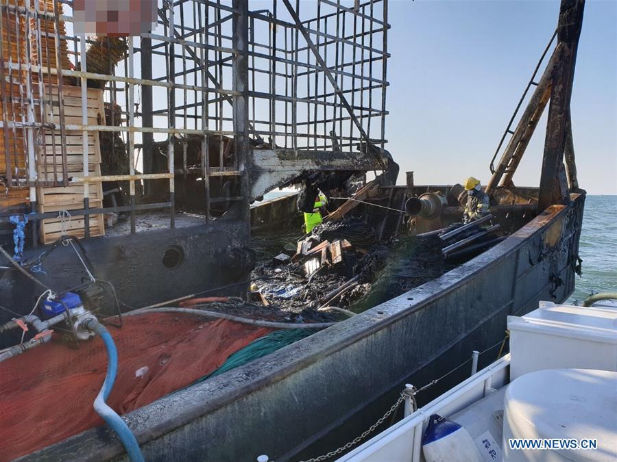 Marine policemen work on the fishing boat in the southwest waters of South Korea, Jan. 17, 2019. A fishing boat caught fire in the southwest waters of South Korea on Thursday morning, leaving one person dead, one missing and one wounded. (Xinhua)