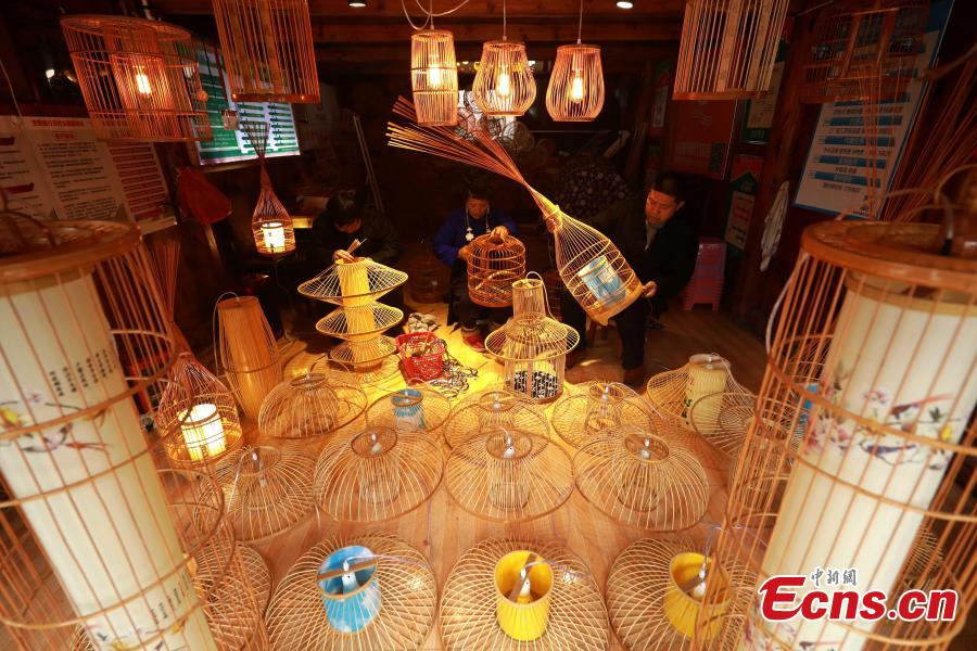 Villagers make bird cage-shaped lanterns, to be used in Chinese New Year celebrations, in Kala Village, Danzhai County, Southwest China\'s Guizhou Province, Jan. 17, 2019. Wang Yuhe is a master of the craft, recognized as an intangible cultural heritage by the province in 2008. The village is famous for producing bird cage-shaped lanterns. (Photo: China News Service/Huang Xiaohai)