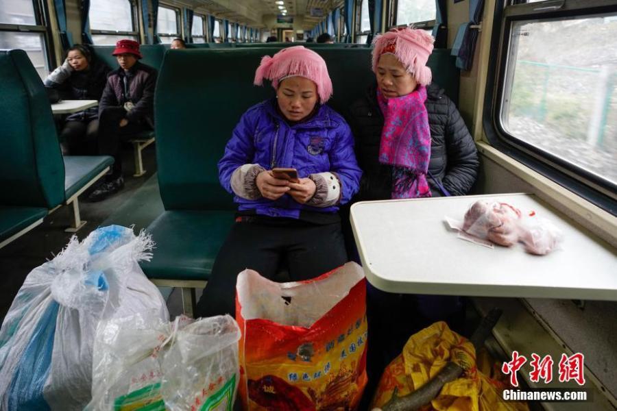 Passengers are seen on a train to Guiyang City, Guizhou Province, Jan. 17, 2019. The railway line linking Guiyang City and Yuping County in Tongren County has been running for 44 years - opening in 1975 - connecting the villages of the many ethnic groups residing deep in the mountains with the outside world. The 342-km journey takes about seven hours - incredibly slow when compared with the speeds of China\'s increasingly ubiquitous bullet trains. (Photo: China News Service/He Junyi)