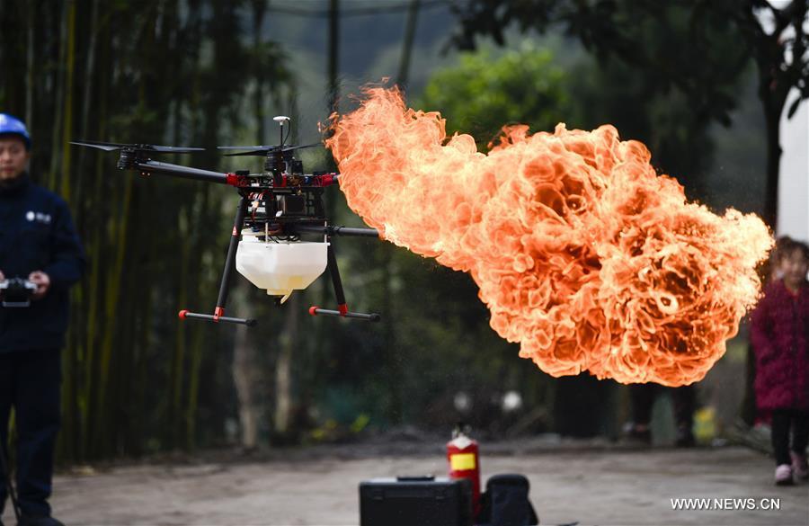 A flame-spurting drone is seen during a demonstration in Chongqing, southwest China, Jan. 16, 2019. The drone was developed by Chongqing\'s Yongchuan company of the State Grid corporation to help clear harmful obstacles hanging on overhead wires. (Xinhua/Liu Chan)