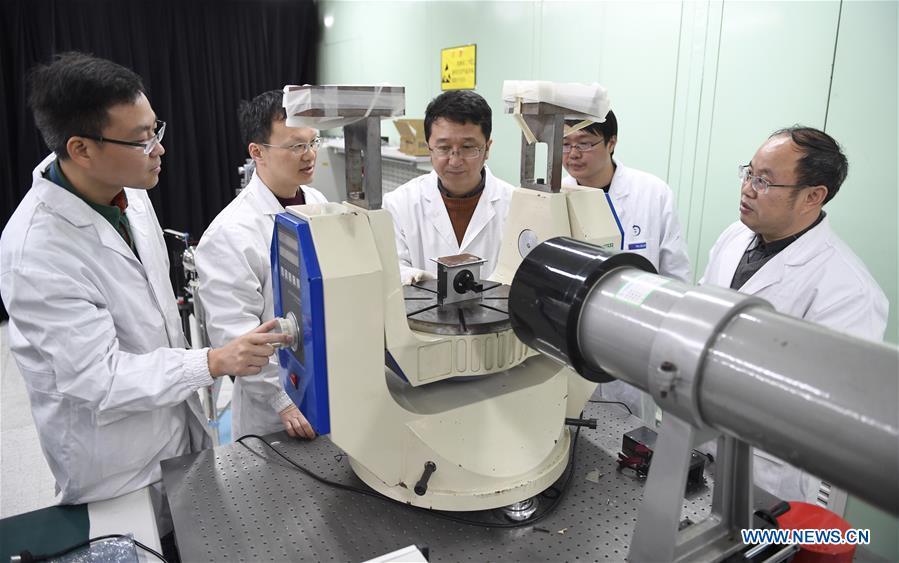 Staff members of Institute of Optics and Electronics of the Chinese Academy of Sciences examine the topographical camera installed on the lander of the Chang\'e-4 probe in Chengdu, southwest China\'s Sichuan Province, Jan. 17, 2019. The topographical camera installed on the lander of the Chang\'e-4 probe is responsible for both taking colorful high-resolution images on the lunar surface and monitoring the lunar rover Yutu-2. China\'s Chang\'e-4 lunar probe, comprising a lander and a rover, landed on the far side of the moon on Jan. 3, 2019. (Xinhua/Liu Kun)