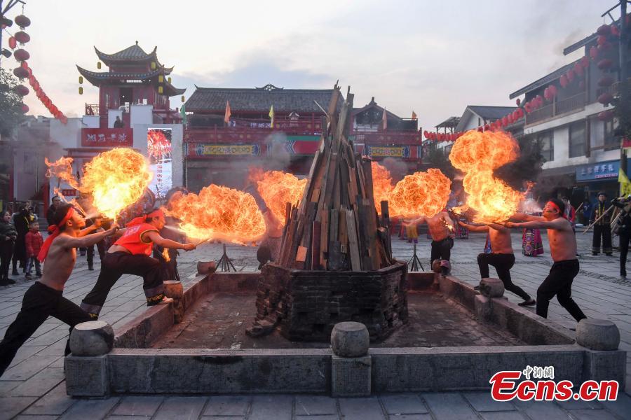 <?php echo strip_tags(addslashes(Performers present a fire stunt show at the Wulingyuan scenic area in Zhangjiajie City, Central China's Hunan Province, Jan. 21, 2019. Zhangjiajie, a UNESCO World Heritage Site, is known for its forest parks and Wulingyuan is famous for its more than 3,000 sandstone pillars. (Photo: China News Service/Yang Huafeng))) ?>