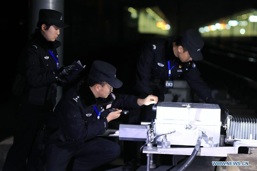 Policemen check the operation of the facilities along the high-speed railway in Rongjiang County, southwest China\'s Guizhou Province, Jan. 22, 2019. Rongjiang Railway Police Station conducts two or three safety inspections at night every week during the Spring Festival travel rush. (Xinhua/Ou Dongqu)