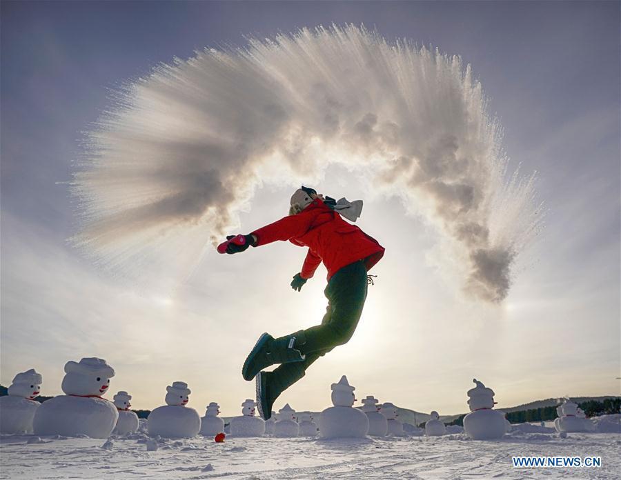 A visitor plays a game with water spray in Beiji Village, Mohe City of northeast China\'s Heilongjiang Province, Jan. 24, 2019. With the lowest temperature approaching minus 30 degrees celsius, visitors in Mohe Village experienced the game of \