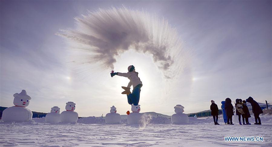 A visitor plays a game with water spray in Beiji Village, Mohe City of northeast China\'s Heilongjiang Province, Jan. 24, 2019. With the lowest temperature approaching minus 30 degrees celsius, visitors in Mohe Village experienced the game of \
