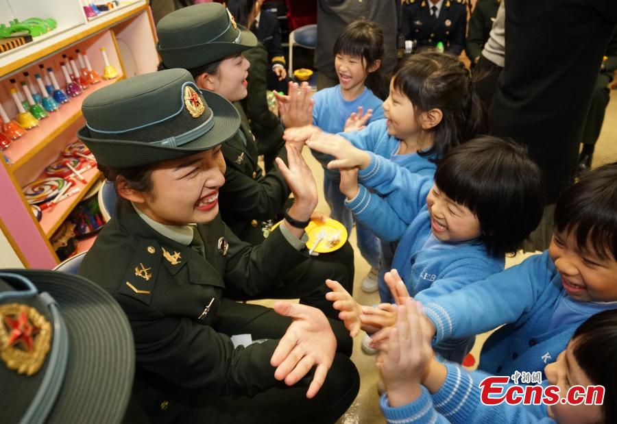 Members of the PLA troops stationed in Hong Kong play games with children at Ka Fuk Baptist Church Pre-School to celebrate the upcoming Spring Festival, China\'s Lunar New Year, in Hong Kong, Jan. 24, 2019. (Photo: China News Service/Zhang Wei)