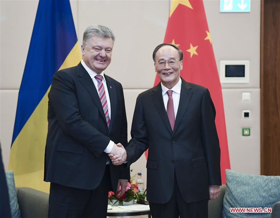 Chinese Vice President Wang Qishan (R) meets with Ukrainian President Petro Poroshenko during the 2019 Annual Meeting of the World Economic Forum in Davos, Switzerland. Wang delivered a speech titled \