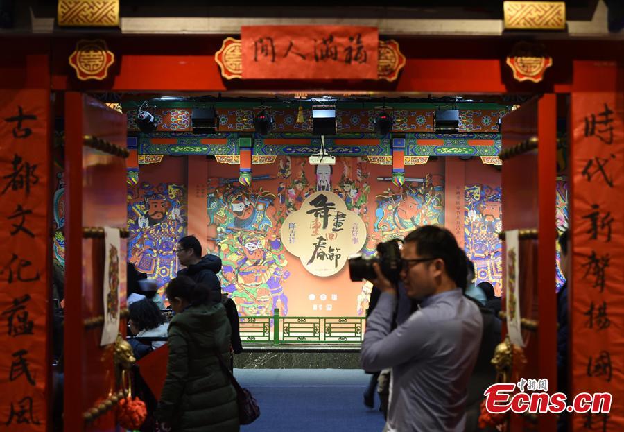 Visitors watch a performance during an exhibition of Spring Festival paintings held at Lao She Tea house in Beijing, Jan. 27, 2019. The exhibition, organized by the Ministry of Culture and Tourism and Prince Gong\'s Mansion, presented representative traditional paintings of the Lunar New Year from across the country, and will run from Jan. 28 to Feb. 28. (Photo: China News Service/Hou Yu)
