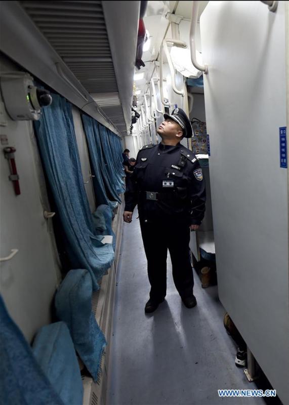 A railway policeman patrols on train No. 6245 which travels from Qiqihar to Gulian in northeast China\'s Heilongjiang Province, Jan. 22, 2019. Train No. 6245 is one of China\'s most economical railway trains which are bound for remote destinations. During China\'s Spring Festival travel season, these \