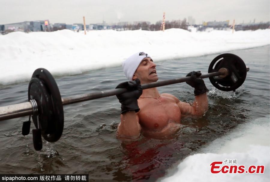 Bodybuilding and fitness trainer Andrei Lobkov sets a new world record for the most consecutive bench presses in 1 minute while standing in an ice hole, in the frozen Moskva River in north-west Moscow; the barbell is half the weight of Lobkov; Lobkov dedicated his record attempt to John the Baptist. (Photo/Sipaphoto.com)