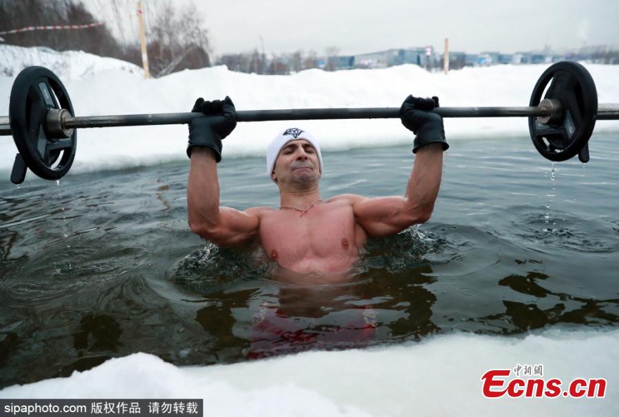 Bodybuilding and fitness trainer Andrei Lobkov sets a new world record for the most consecutive bench presses in 1 minute while standing in an ice hole, in the frozen Moskva River in north-west Moscow; the barbell is half the weight of Lobkov; Lobkov dedicated his record attempt to John the Baptist. (Photo/Sipaphoto.com)