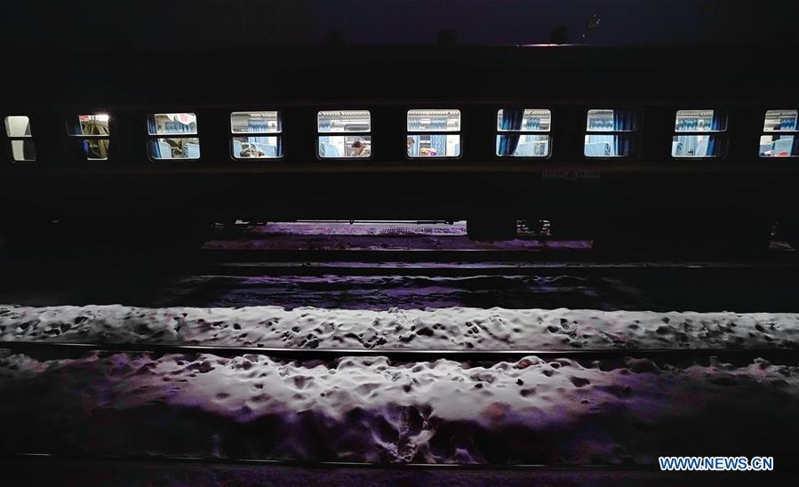 Passengers are seen on train No. 6245 which travels from Qiqihar to Gulian in northeast China\'s Heilongjiang Province, early on Jan. 23, 2019. Train No. 6245 is one of China\'s most economical railway trains which are bound for remote destinations. During China\'s Spring Festival travel season, these \