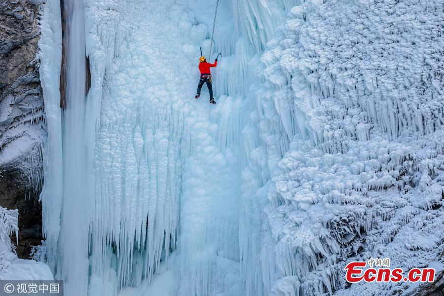 Climbers ascend the ice Torrente Rosandra waterfall, frozen first time in ten years, in Italy, as temperatures dropped to minus seven degrees. (Photo/VCG)