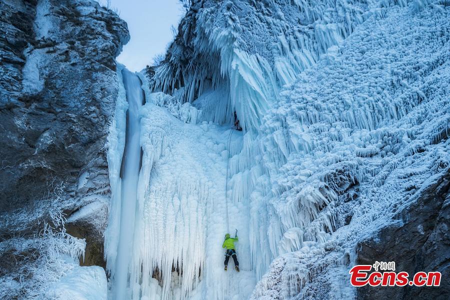 Climbers ascend the ice Torrente Rosandra waterfall, frozen first time in ten years, in Italy, as temperatures dropped to minus seven degrees. (Photo/VCG)