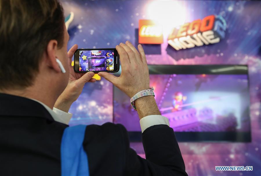 A visitor records video at the booth of LEGO in the Spielwarenmesse exhibition in Nuremberg, Germany, Jan. 30, 2019. Spielwarenmesse, a leading international fair for toys, hobbies and leisure, kicked off in Nuremberg on Wednesday. Around 2,900 manufacturers from all over the world gathered at the annual trade fair, which will last until Feb. 3 and is expected to attract 71,000 visitors from over 125 nations and regions. (Xinhua/Shan Yuqi)