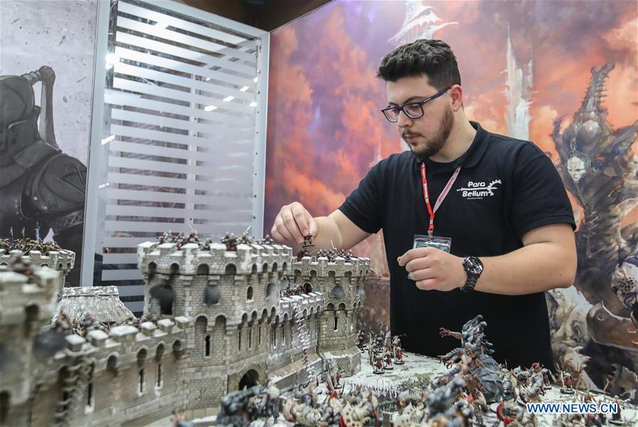 A staff member of the booth of Para Bellum adjusts model figures in the Spielwarenmesse exhibition in Nuremberg, Germany, Jan. 30, 2019. Spielwarenmesse, a leading international fair for toys, hobbies and leisure, kicked off in Nuremberg on Wednesday. Around 2,900 manufacturers from all over the world gathered at the annual trade fair, which will last until Feb. 3 and is expected to attract 71,000 visitors from over 125 nations and regions. (Xinhua/Shan Yuqi)