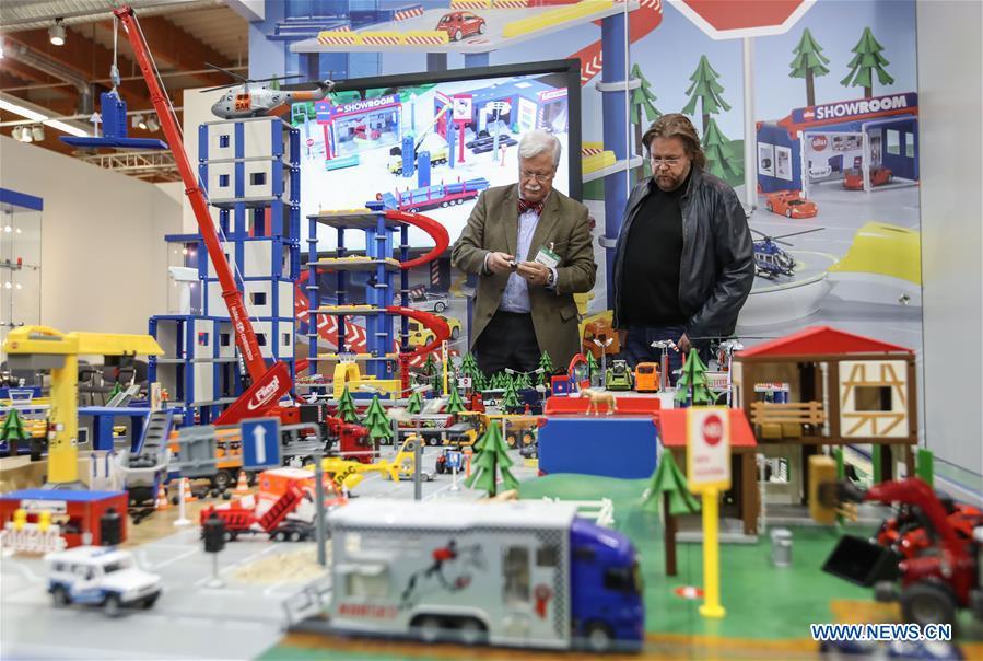 Two visitors view products at the booth of Siku in the Spielwarenmesse exhibition in Nuremberg, Germany, Jan. 30, 2019. Spielwarenmesse, a leading international fair for toys, hobbies and leisure, kicked off in Nuremberg on Wednesday. Around 2,900 manufacturers from all over the world gathered at the annual trade fair, which will last until Feb. 3 and is expected to attract 71,000 visitors from over 125 nations and regions. (Xinhua/Shan Yuqi)