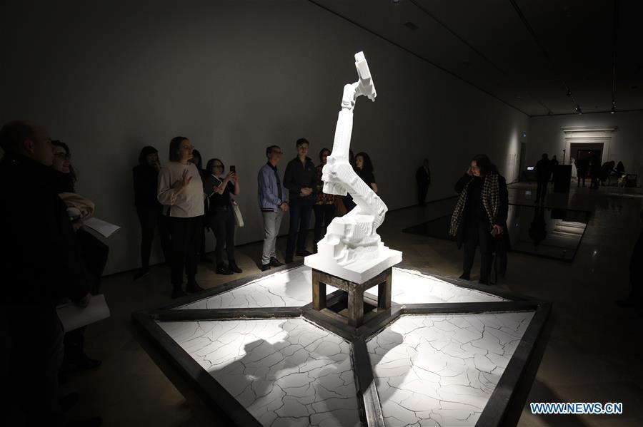 Participants in a workshop look at a robot arm during the third edition of the Night of Ideas in Warsaw, Poland, on Jan. 31, 2019. The sculpture was made by a robot from marble sourced from the Italian region of Carrara. The Night of Ideas is a yearly art show with debates and workshops held at the Center for Contemporary Art in Ujazdow Castle and organized by the French Institute. (Xinhua/Jaap Arriens)