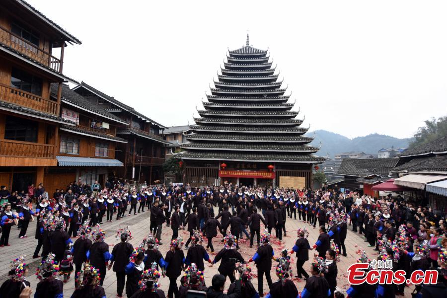Nearly 200 women of the Dong ethnic group attend a group activity that shows the traditional custom of outmarried women going back to the home of their parents, often donning grand costumes and carrying gifts, in Pingyan Village, Sanjiang Dong Autonomous County, Guangxi Zhuang Autonomous Region, Feb. 1, 2019. The custom has become a draw that attracts tourists. (Photo: China News Service/Gong Pukang)