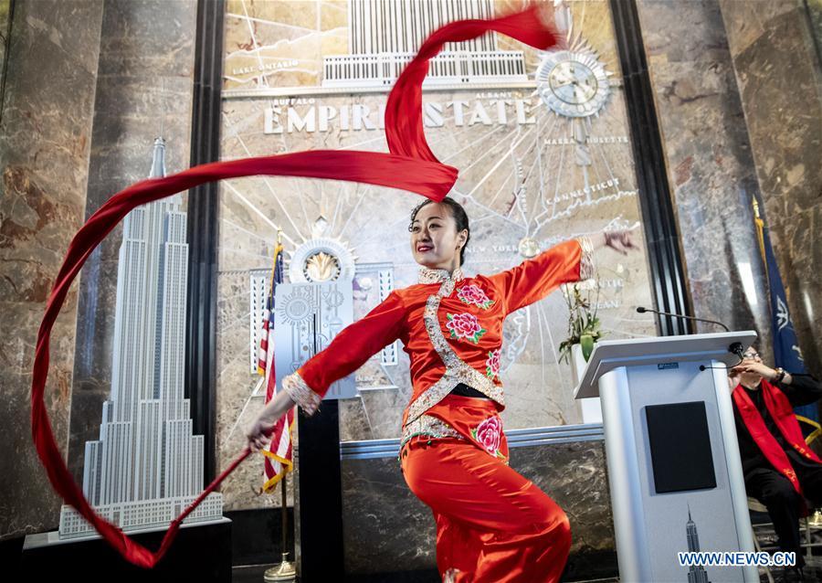 <?php echo strip_tags(addslashes(A dancer performs during the lighting ceremony for Chinese Spring Festival at the Empire State Building in Manhattan, New York, the United States, on Feb. 1, 2019. The top of the landmark Empire State Building in Manhattan will shine in red, blue and yellow on the nights of next Monday and Tuesday to celebrate the Chinese New Year, which falls on Feb. 5 this year. (Xinhua/Wang Ying))) ?>