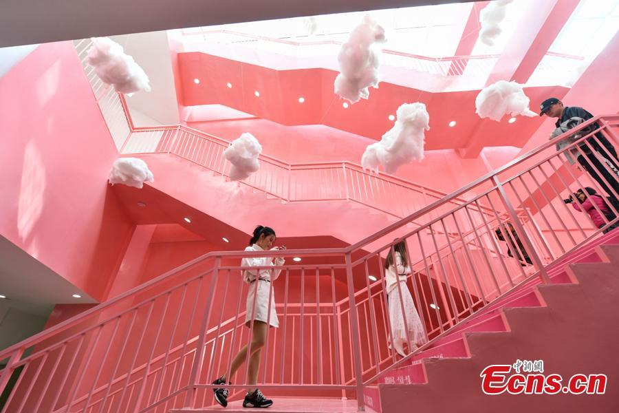 Passengers walk on pink stairs at the exit of Chunrong Street Subway Station in Kunming City, Southwest China’s Yunnan Province. With cotton clouds suspended in the air and cute love quotes written on the stairs, the pink subway station has quickly gained widespread traction among young people. (Photo: China News Service/Ren Dong)