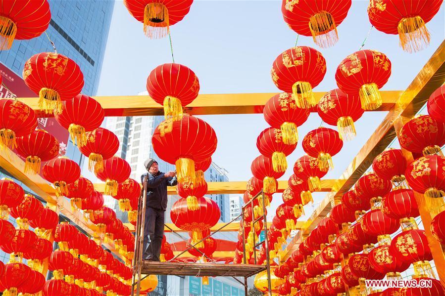 A worker hangs red lanterns for the upcoming Spring Festival at the gate of a shopping mall in Handan City, north China\'s Hebei Province, Feb. 1, 2019. The Spring Festival, or the Chinese Lunar New Year, falls on Feb. 5 this year. (Xinhua/Qiao Hailong)
