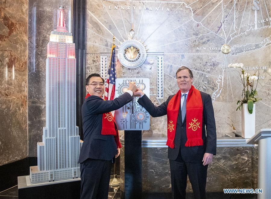 Chinese Consul General in New York Huang Ping (L) and John B. Kessler, president of the Empire State Realty Trust Inc., flip the switch to light a model of Empire State Building during the lighting ceremony for Chinese Spring Festival at the Empire State Building in Manhattan, New York, the United States, on Feb. 1, 2019. The top of the landmark Empire State Building in Manhattan will shine in red, blue and yellow on the nights of next Monday and Tuesday to celebrate the Chinese New Year, which falls on Feb. 5 this year. (Xinhua/Wang Ying)