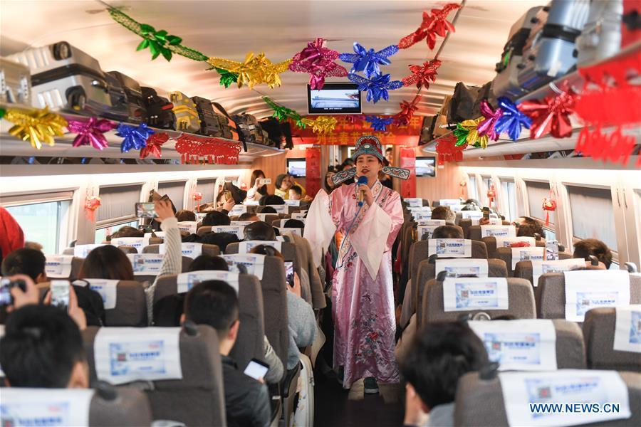 An attendant performs aboard a bullet train from Hangzhou of east China\'s Zhejiang Province to Huangshan of east China\'s Anhui Province, on Feb. 2, 2019. Staff members aboard the train staged a performance Saturday to extend greetings to the passengers, ahead of the Spring Festival, or the Chinese Lunar New Year, which falls on Feb. 5 this year. (Xinhua/Huang Zongzhi)