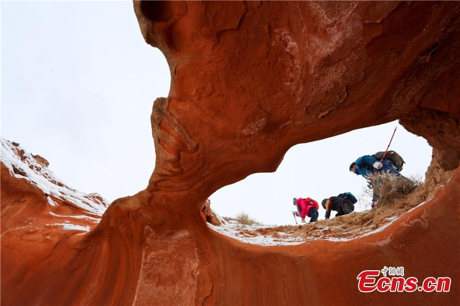 <?php echo strip_tags(addslashes(Tourists visit the snow-covered Danxia landform in Sunan Yugur Autonomous County, Northwest China's Gansu Province during the Spring Festival holiday. The Danxia landform is a unique type of geomorphology formed from red-colored sandstone and characterized by steep cliffs. (Photo: China News Service/Wang Jiang))) ?>