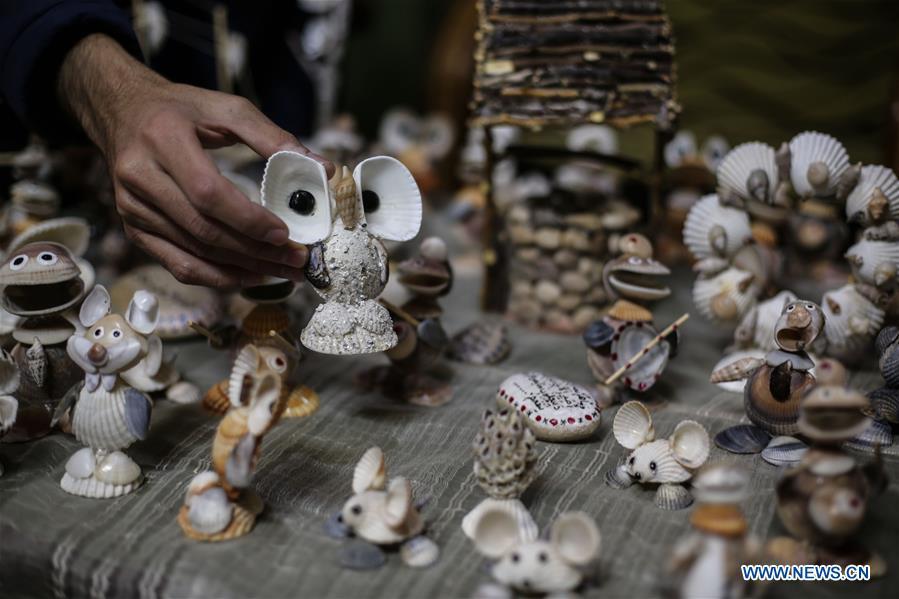<?php echo strip_tags(addslashes(Palestinian young man Ahmed al-Madhoun, 31, displays art pieces he made with seashells at his house in Gaza City, on Feb. 10, 2019. A Palestinian young man from Gaza turns seashells into beautiful artifacts that adorn his home to satisfy his passion for this type of art. Using seashells he collects from Gaza beaches, 31-year-old Ahmed al-Madhoun makes various art pieces such as animals, birds and some funny characters. Al-Madhoun, who holds a college degree in radio and television engineering and works for a local telecommunication company, has been collecting multiple forms of seashells from the Gaza seashore for more than four years. The young man began the hobby of seashell art about a year and a half ago, and he already made large numbers of art pieces. (Xinhua/Stringer))) ?>
