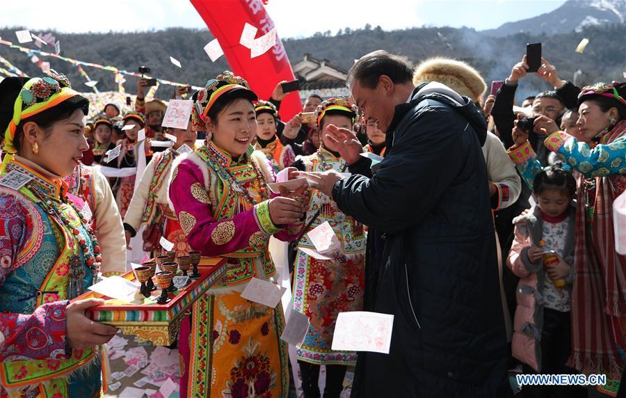 People of Tibetan ethnic group serve alcoholic drink during the Shangjiu Festival at the foot of Jiajin Mountain in the Tibetan Township of Qiaoqi in Ya\'an City, southwest China\'s Sichuan Province, Feb. 13, 2019. The Shangjiu Festival, a traditional festival of the Tibetan people, is celebrated on the ninth day of the first lunar month to pray for a good harvest. (Xinhua/Jiang Hongjing)