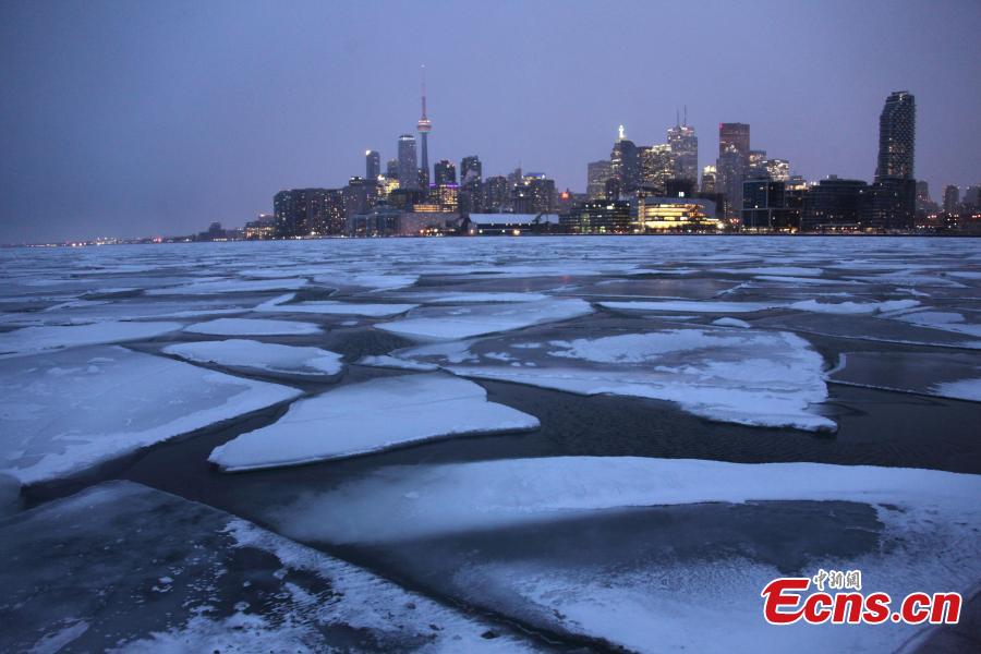 Toronto skyline is seen with floating ice on Lake Ontario in Toronto, Canada, on Feb. 13, 2019. A winter storm of a mix of snow, freezing rain and strong winds hit the Greater Toronto Area from Tuesday to Wednesday. (Photo/China News Service)