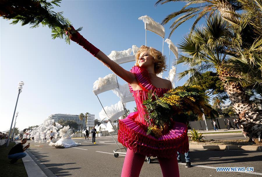 A performer distributes flowers during the parade of Nice Carnival with the theme \