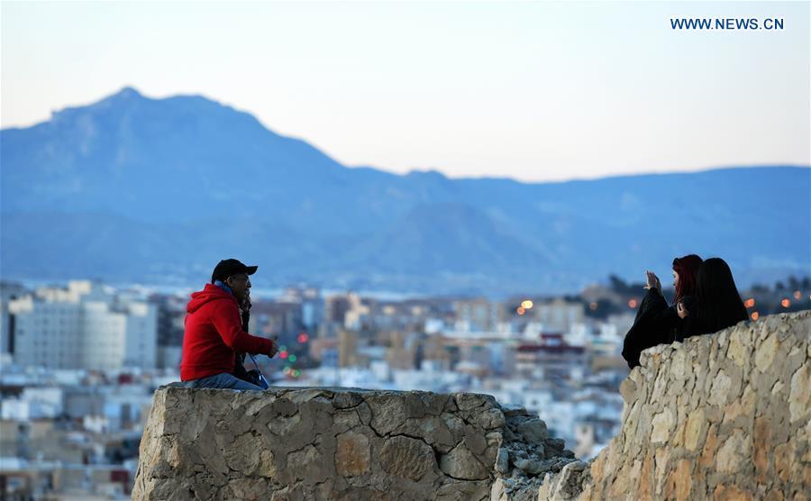 <?php echo strip_tags(addslashes(Tourists take pictures by the Santa Barbara Castle in the city of Alicante, Spain, Feb. 16, 2019. (Xinhua/Guo Qiuda))) ?>